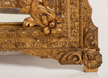 null Important mirror with parecloses in wood and gilded stucco, the pediment decorated...