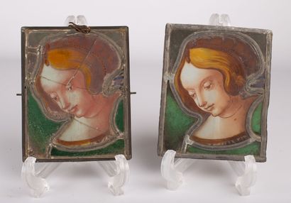 null Two stained glass windows depicting women's profiles, eyes lowered. 

In the...