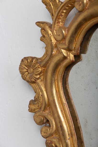 null Pair of carved and gilded wood mirrors decorated with interlacing and flowers.

South...