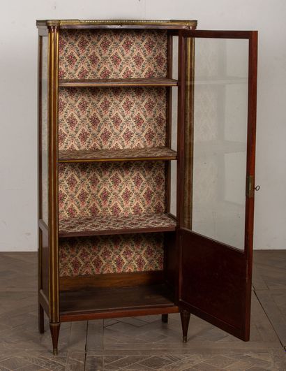 null Mahogany and mahogany veneer showcase, with fluted uprights and brass curls.

Louis...