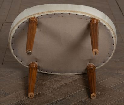 null Oval stool in molded wood, the tapered legs with cut sides. 

Beginning of the...
