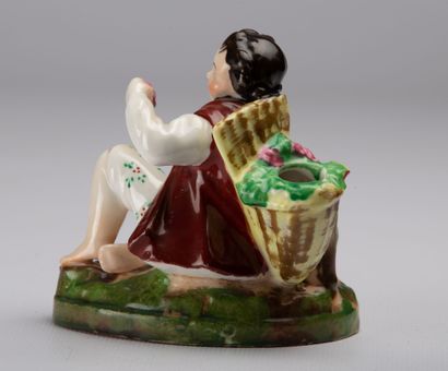 null PARIS.

Inkwell forming a pen-rest in polychrome porcelain representing a grape-picker.

Napoleon...