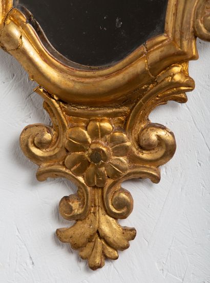 null Pair of carved and gilded wood mirrors decorated with interlacing and flowers.

South...
