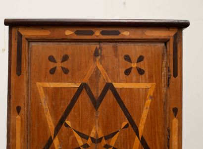 null Cupboard in marquetry of fruitwood, with geometrical decorations.

It opens...