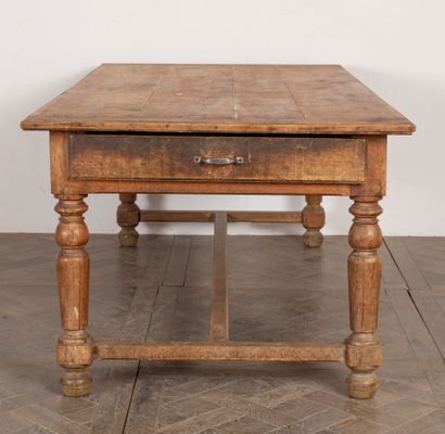 null Community table in molded oak, opening with two drawers, one on each side. 

The...