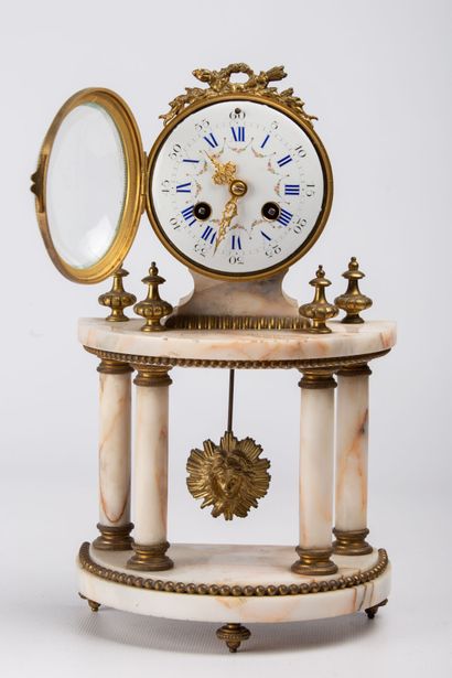 null Bronze and marble mantelpiece. 

The terminal clock with enamelled dial resting...