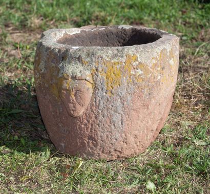Mortar in pink sandstone with archaic man's...