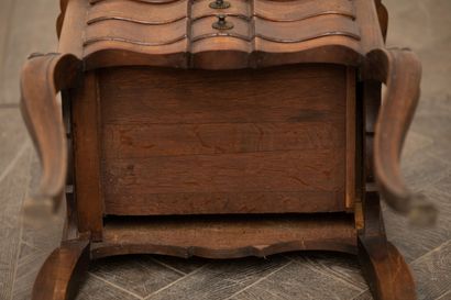 null Three-drawer lounge table in molded and carved wood.

The curved legs carved...