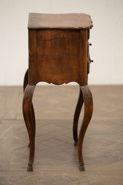 null Three-drawer lounge table in molded and carved wood.

The curved legs carved...