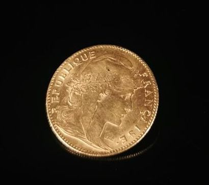 null 10 francs gold coin with rooster.

1911.

3.24 grams