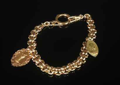 null Bracelet en or retenant deux médailles religieuses en guise de breloque.

L_...