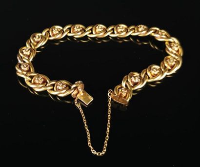 null Bracelet en or jaune à maille gourmette et motif floral.

Avec sa chaîne de...