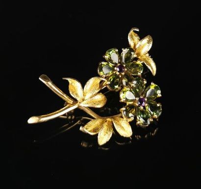 null Gold brooch featuring a flower decorated with peridots and amethysts.
Not signed.
H_4,6...