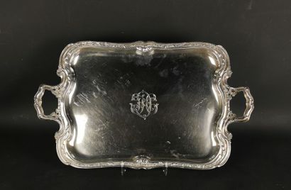 null Tray with handles in silver, with rocaille decoration.
Numerated in its center.
L_...