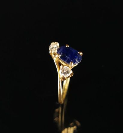 null Asymmetrical yellow gold ring set with an oval sapphire, a brilliant-cut diamond...