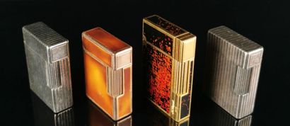 null S.T. DUPONT.
Reunion of four silver and gilt metal lighters, the two gilt lighters...