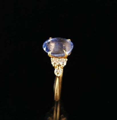 null Yellow gold ring adorned with a blue-tinted stone and set with brilliant-cut...
