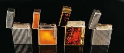 null S.T. DUPONT.
Reunion of four silver and gilt metal lighters, the two gilt lighters...