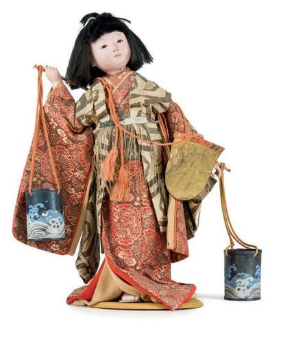 JAPON - XXe siècle A young woman's standing doll, dressed in a beige brown silk kimono...