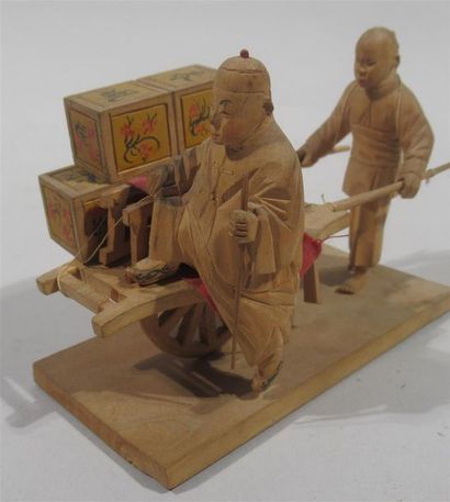 null Sculpture en bois d'un homme et son fils transportant dans une charrette des...