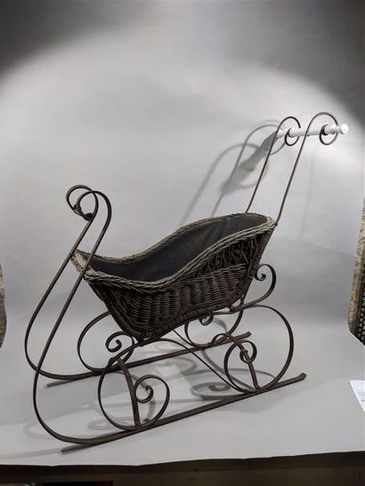 null Sleigh, the woven wicker cradle resting on a wrought iron frame with white porcelain...