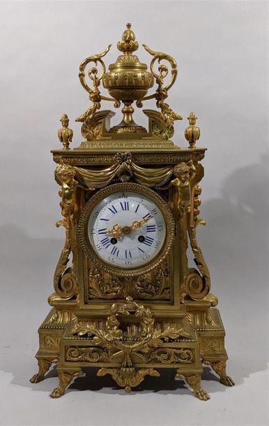 null Portico clock in chased and gilded bronze with putti decoration supporting draperies,...