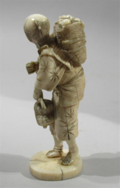 null OKIMONO in finely carved ivory with a beautiful patina of a peasant with his...