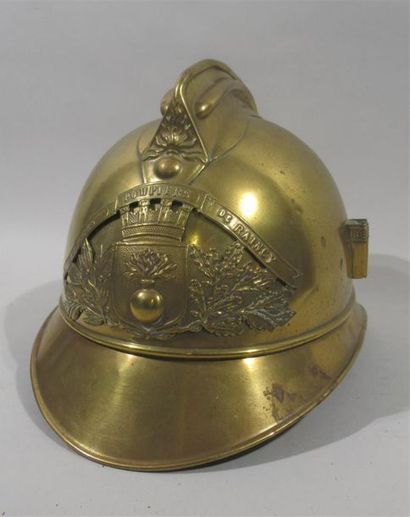 null Raincy's brass fireman's helmet, decorated with a coat of arms surrounded by...