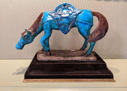 null Terracotta sculpture with blue and brown glaze representing a horse.
Work in...