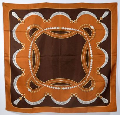 null CARTIER - Printed silk square, titled "Must de Cartier" in brown colour with...