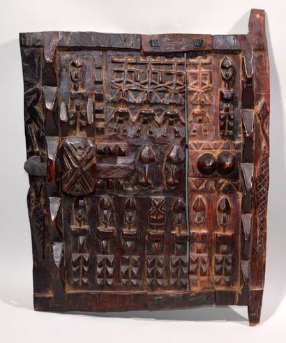 null GRENIER DOOR in patinated wood carved with stylized characters.
Dogon work,...