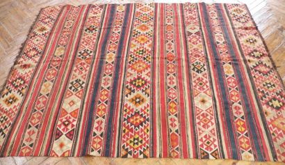 null Woven wool KILIM carpet decorated with red and blue geometric patterns on a...