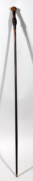 null CANE with wooden shaft and horn pommel carved with one hand holding a cane pommel.

(Some...
