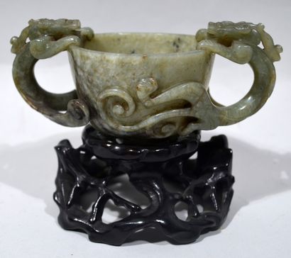 null 
CHINA





Hard stone libation cup with handles and dragon decoration. On openwork...
