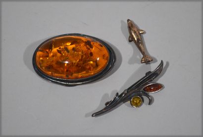 null Set includes two silver-mounted brooches set with amber stone.

Length of the...