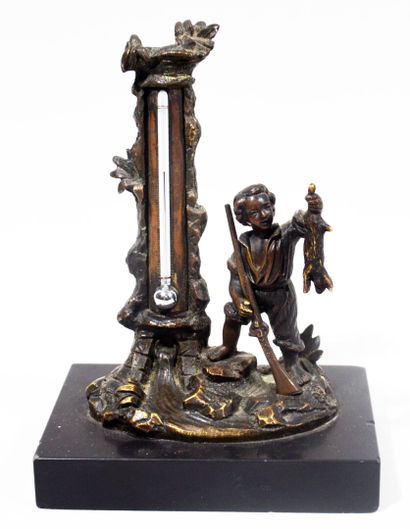 null Bronze group with a brown patina representing a rabbit hunter serving as a thermometer...
