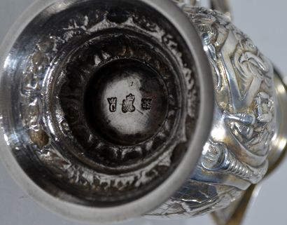 null A solid silver covered ewer resting on a round foot with repoussé decoration...