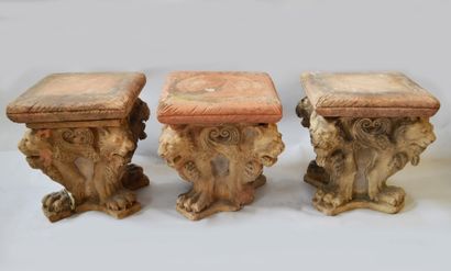 null Suite of three terracotta SOCLES decorated with four lions back to back resting...