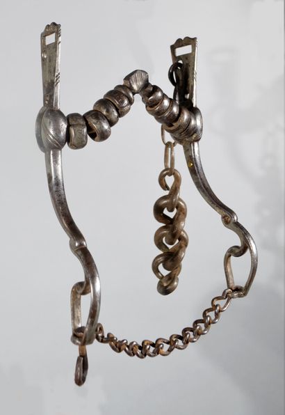 null Old wrought iron bridle bit with articulated tongue passage and the barrel decorated...