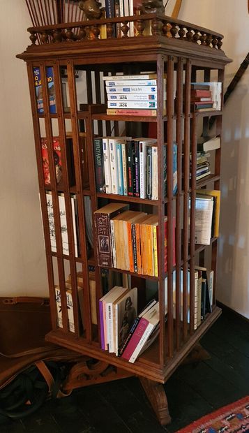 null Revolving bookcase in moulded oak, with four levels of storage, topped by a...