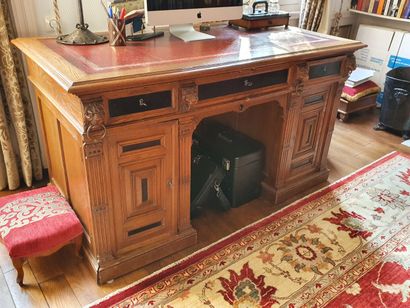null Flat desk in oak partially blackened. The top has a red leather gilded with...