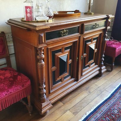 null A partially blackened and moulded oak sideboard, the two full doors decorated...