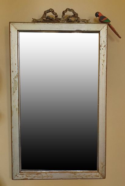 null MIRROR in beveled glass, the frame in gilded lacquered wood and white ceruse...