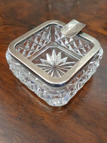 null Pressed moulded crystal ashtray with a silver ingot mould (925/oo) in one slot

ENGLAND,...