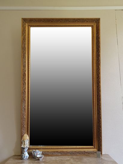null Important bevelled CHIMNEY MIRROR, the frame in stuccoed and gilded wood decorated...