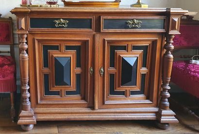 null A partially blackened and moulded oak sideboard, the two full doors decorated...