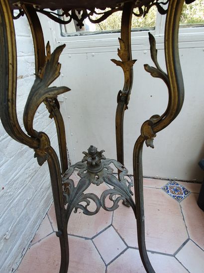 null A copper plant stand with a golden patina. It rests on four cambered legs with...