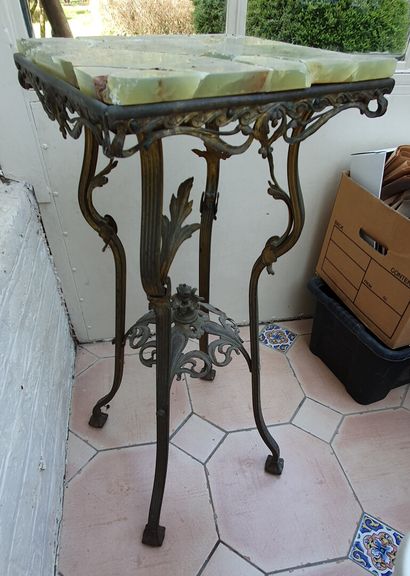null A copper plant stand with a golden patina. It rests on four cambered legs with...