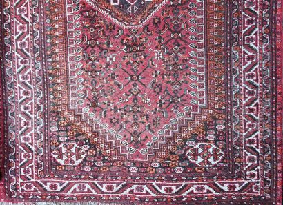 null IRAN

Knotted wool carpet with a central diamond motif on a brick-red background,...
