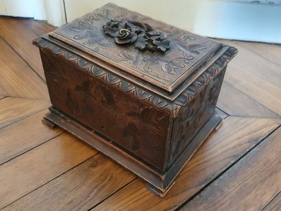 null CIGAR BOX in molded and carved oak opening by a flap revealing three small shelves...